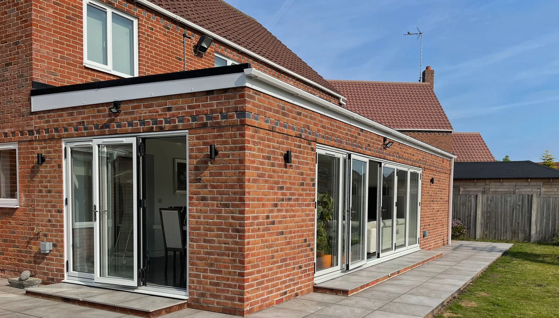 Corner view of the brick rear extension and paved patio