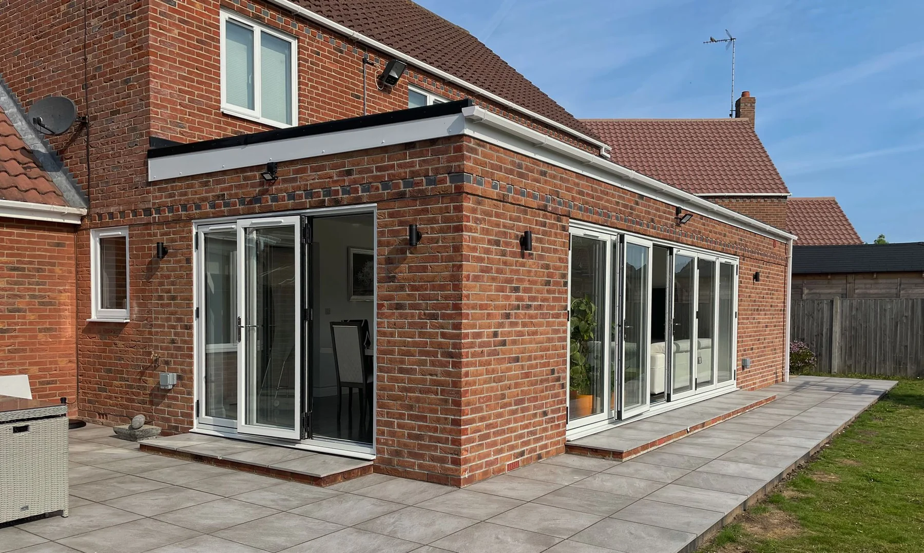 Brick rear extension with patio doors and paved patio